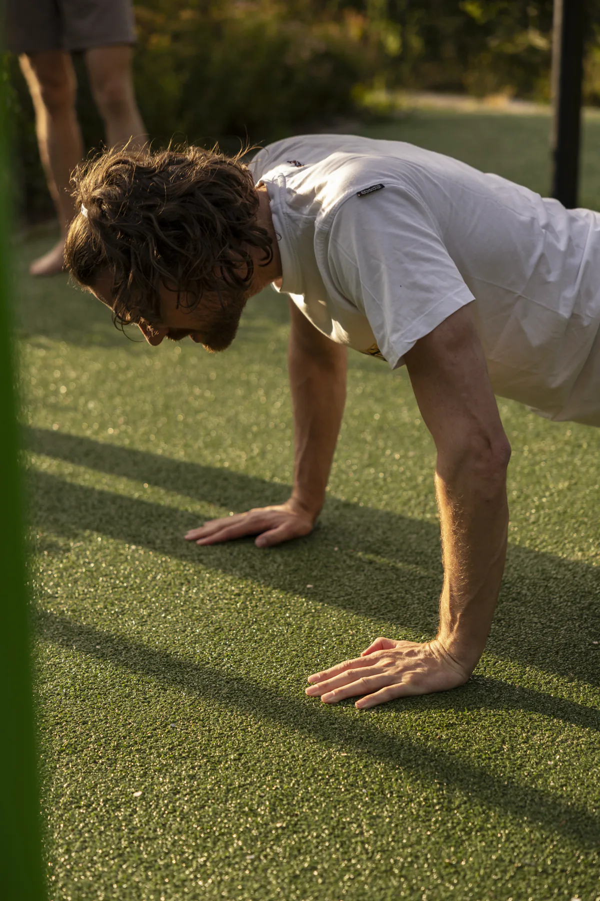 Push-up tijdens het work-outblok van de groepsles op het gras
